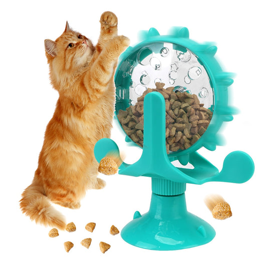Cat playing with a teal pet toy that has a wheel mechanism