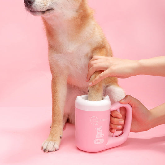 Dog paw bathed in a pink mug with a pink background
