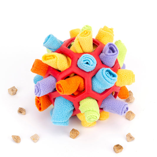 Colorful dog toy with textured surface and small bones around on a white background