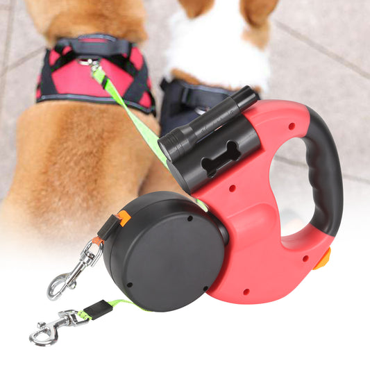 Red and black retractable dog leash with a dog in the background