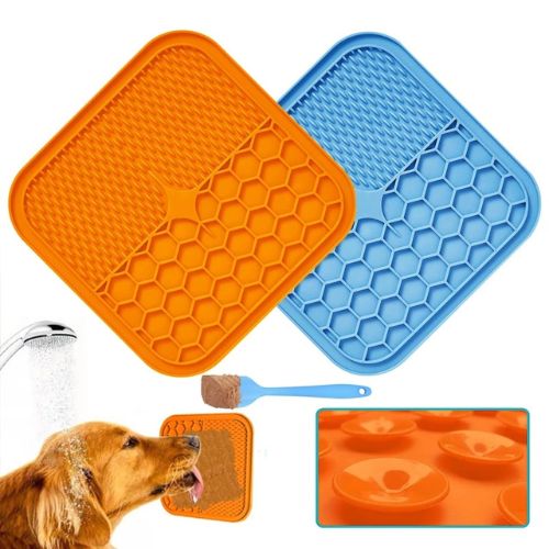 Orange and blue silicone mats with honeycomb pattern, dog drinking water, and additional mat inset.