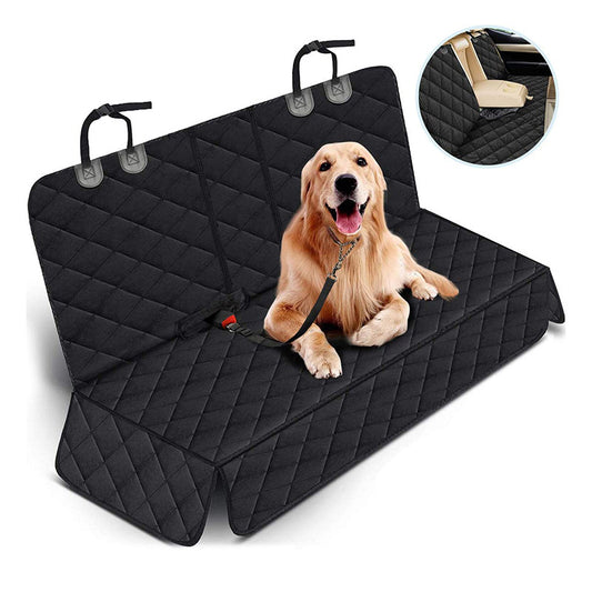 Dog sitting on a black car seat cover with quilted texture, showing close-up of padding.